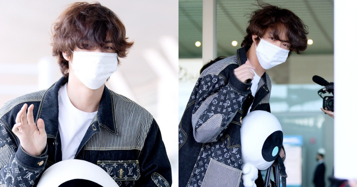 BTS' Jin waves for cameras at airport