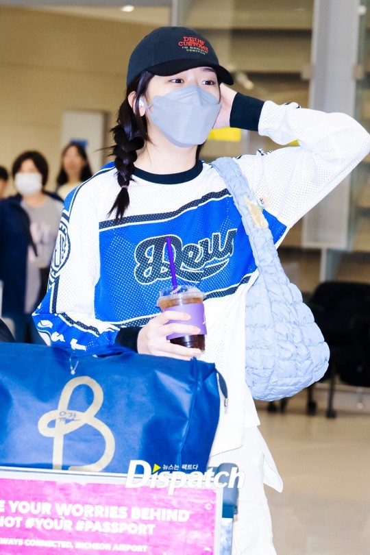 BTS' Jin waves for cameras at airport